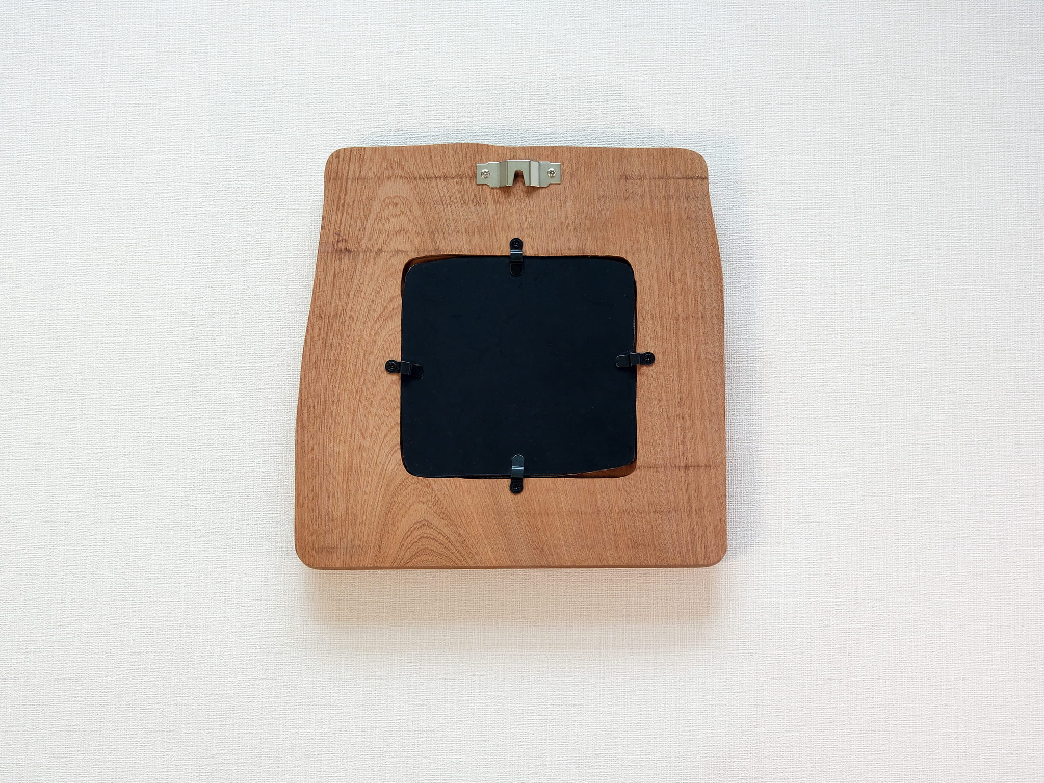 Back view of large handmade solid wood picture frame with wall hanger and removable black backing panel.