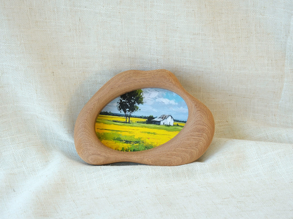 Cloud-shaped wood art frame leaning against a wall, showcasing its decorative, artistic presence in a home setting.