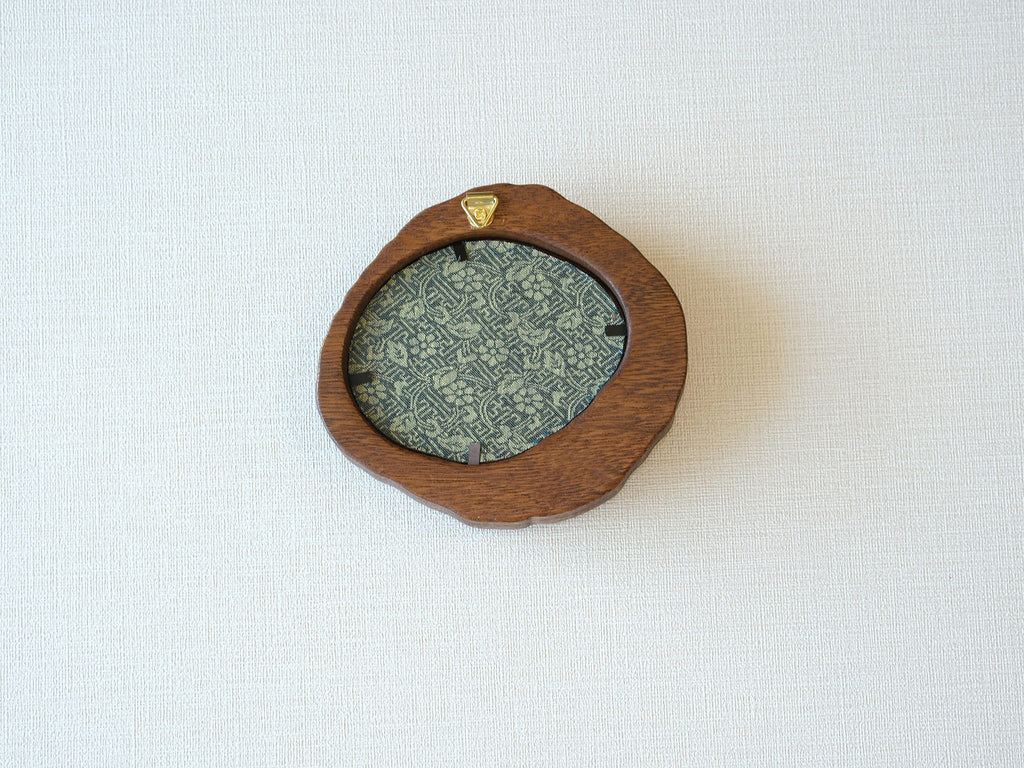 Rear view of the lake-shaped organic solid wood frame, revealing the uniquely patterned blue and gold textile backing and the integrated gold wall hanger.
