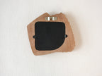 Back view of accordion-inspired solid wood wall hanging picture frame with metal hook and removable back panel.