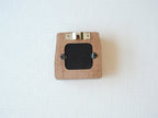 The back view of the mini solid wood frame, showing a silver metal sawtooth hanger for wall mounting and a black backing secured by two turn buttons. The natural grain and clean finish of the Sapele wood are visible on the reverse side.