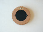 Back view of the sunflower circular frame, showing the wall-mounting hook and easy-open tabs for swapping photos.