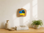 Accordion-inspired solid wood wall hanging picture frame in a warm home setting.