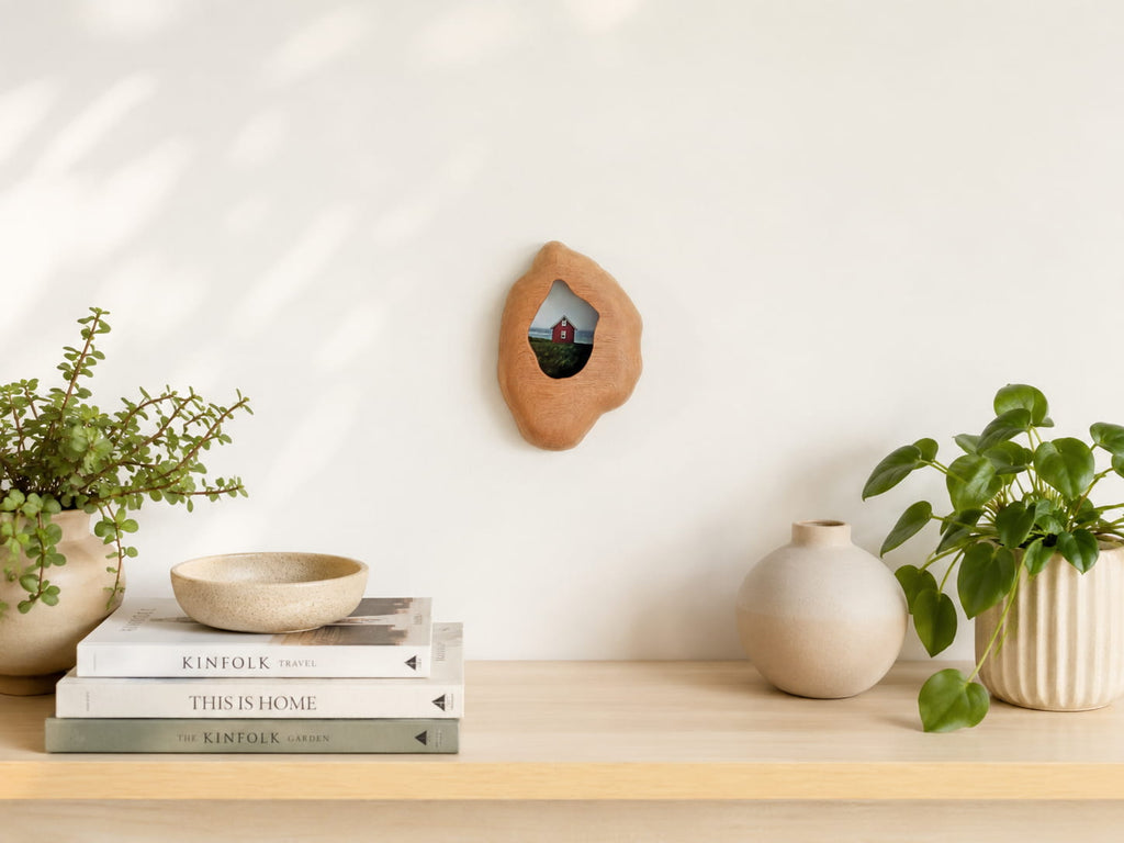 Handmade solid wood wall hanging art picture frame with red house artwork displayed in a warm home interior.