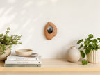 Handmade solid wood wall hanging art picture frame with red house artwork displayed in a warm home interior.