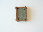 Back view of the organic solid wood frame, showing the elegant green patterned backing fabric and black metal retainer clips.