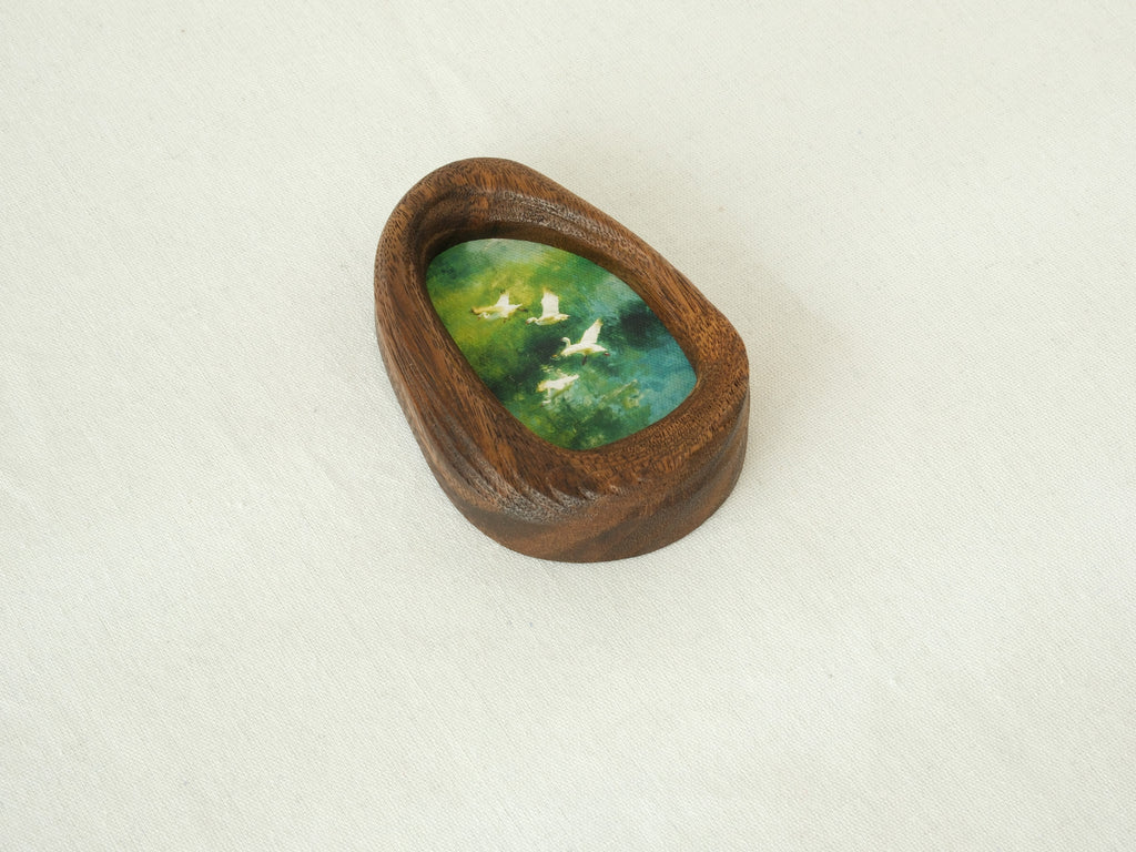 Angled view of the waterdrop-shaped solid wood frame, highlighting the natural grain patterns and the elegant curves of the hand-carved pebble silhouette.