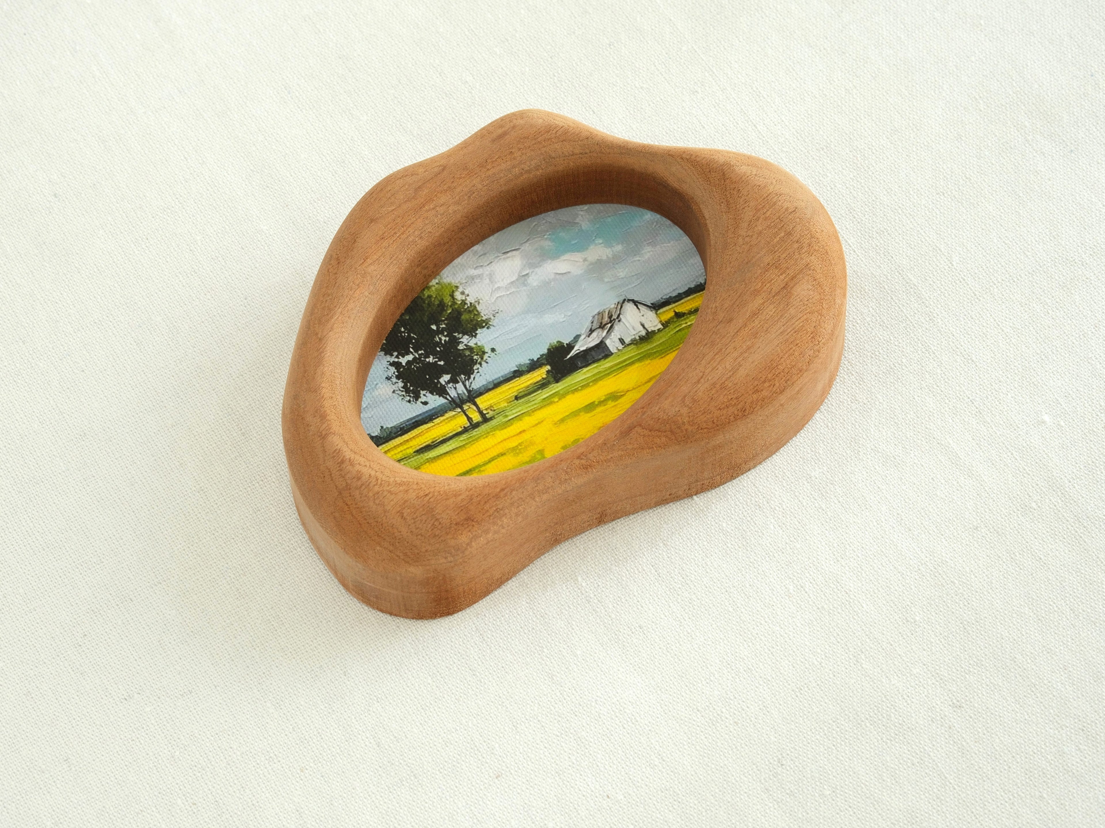 Side view of the cloud-shaped wood art frame, showing hand-sculpted organic curves and its sculptural depth.