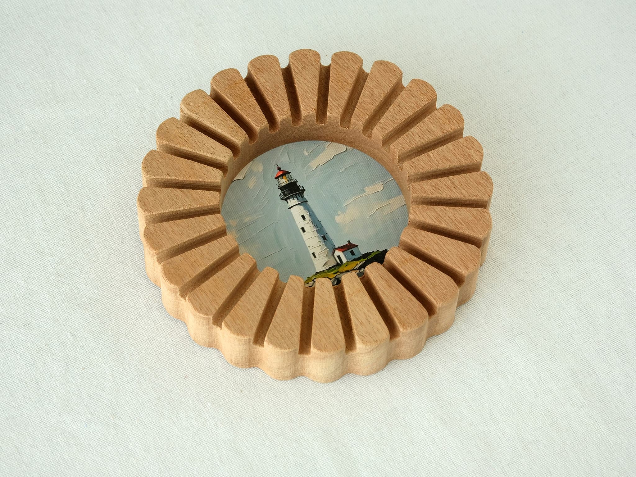 A high-angle view of the sunflower circular solid wood frame lying on a white textured surface, highlighting its natural wood grain.