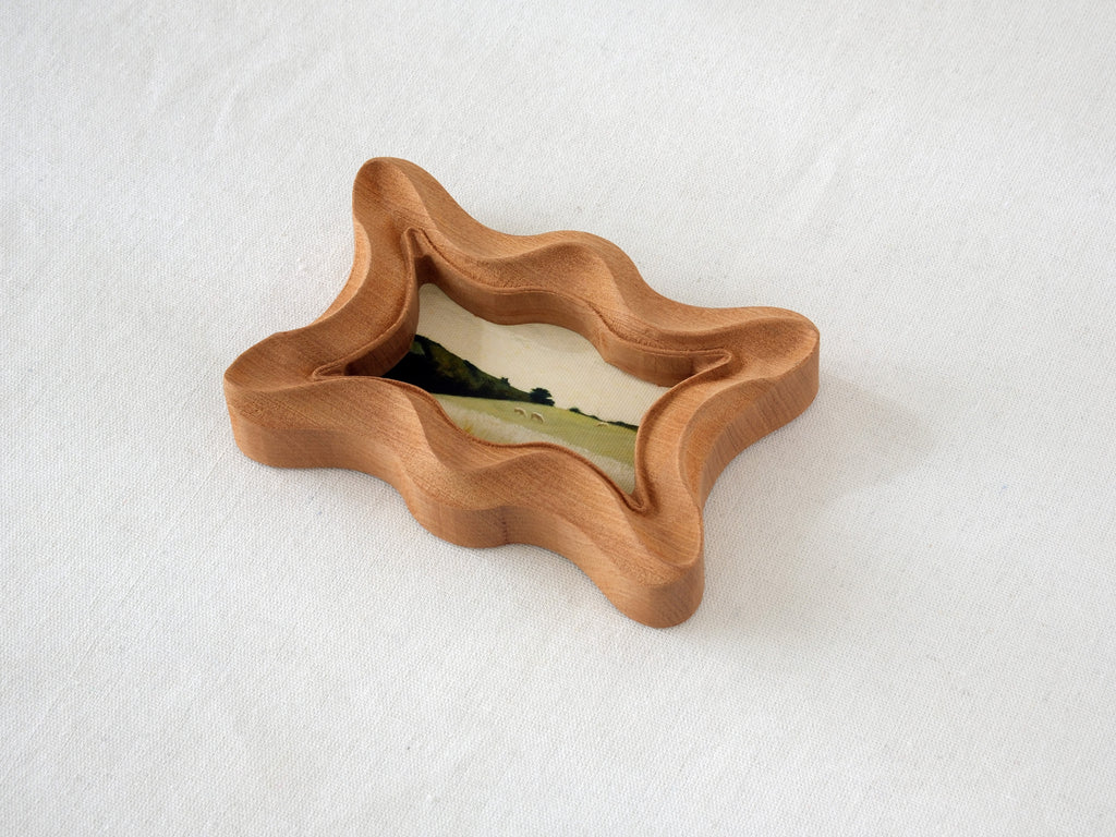 Alternative angled view of the rippled wave wood frame, showcasing its rhythmic undulating edges and artisan craftsmanship.