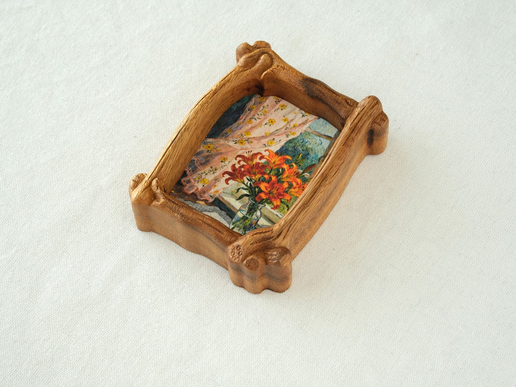 High-angle view of the organic solid wood frame, showing the natural wood grain and handcrafted sculptural details.