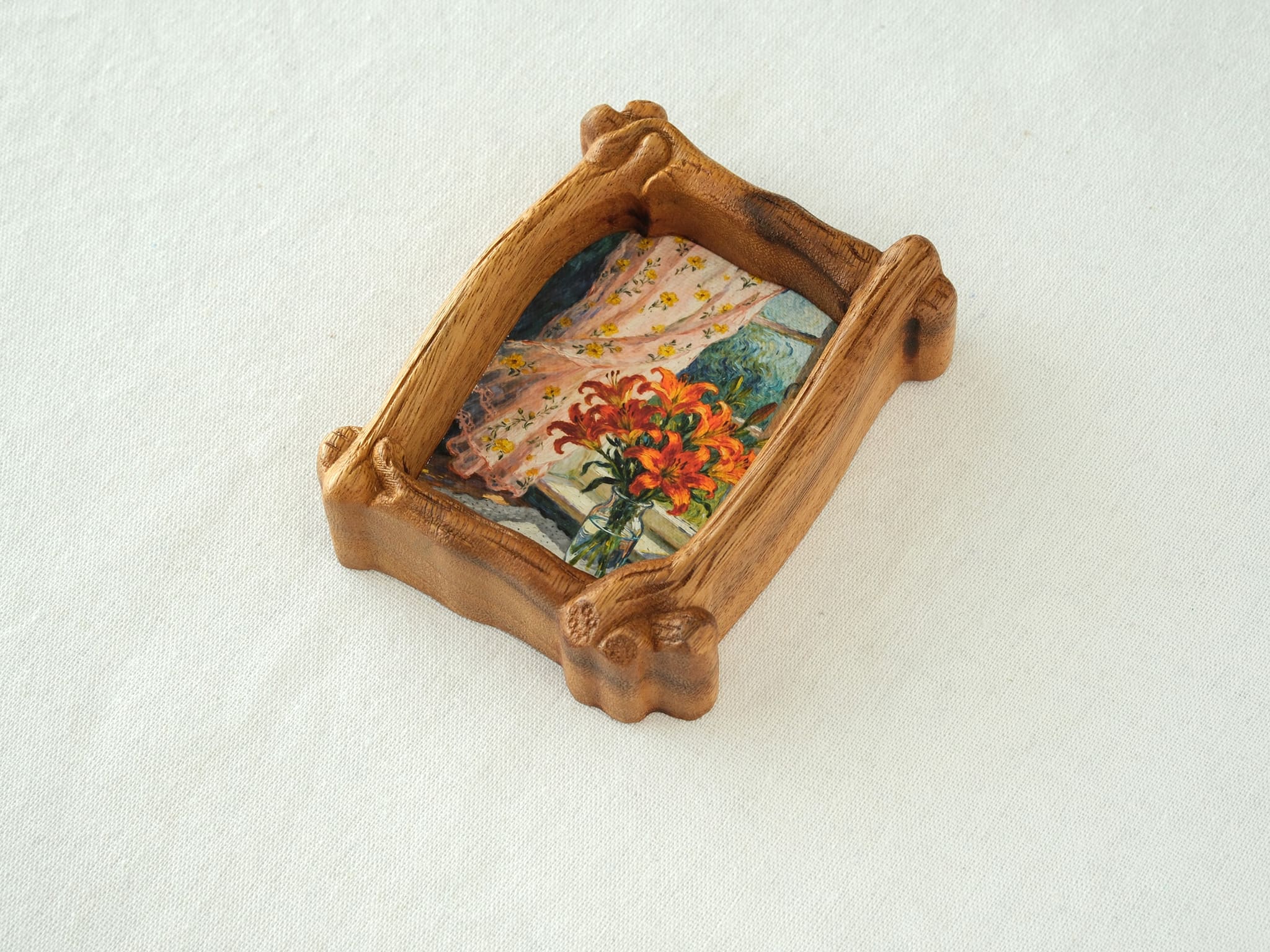 High-angle view of the organic solid wood frame, showing the natural wood grain and handcrafted sculptural details.