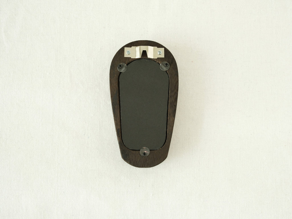 Back view of the black arched frame, featuring an integrated metal wall hanger and three secure swivel tabs.