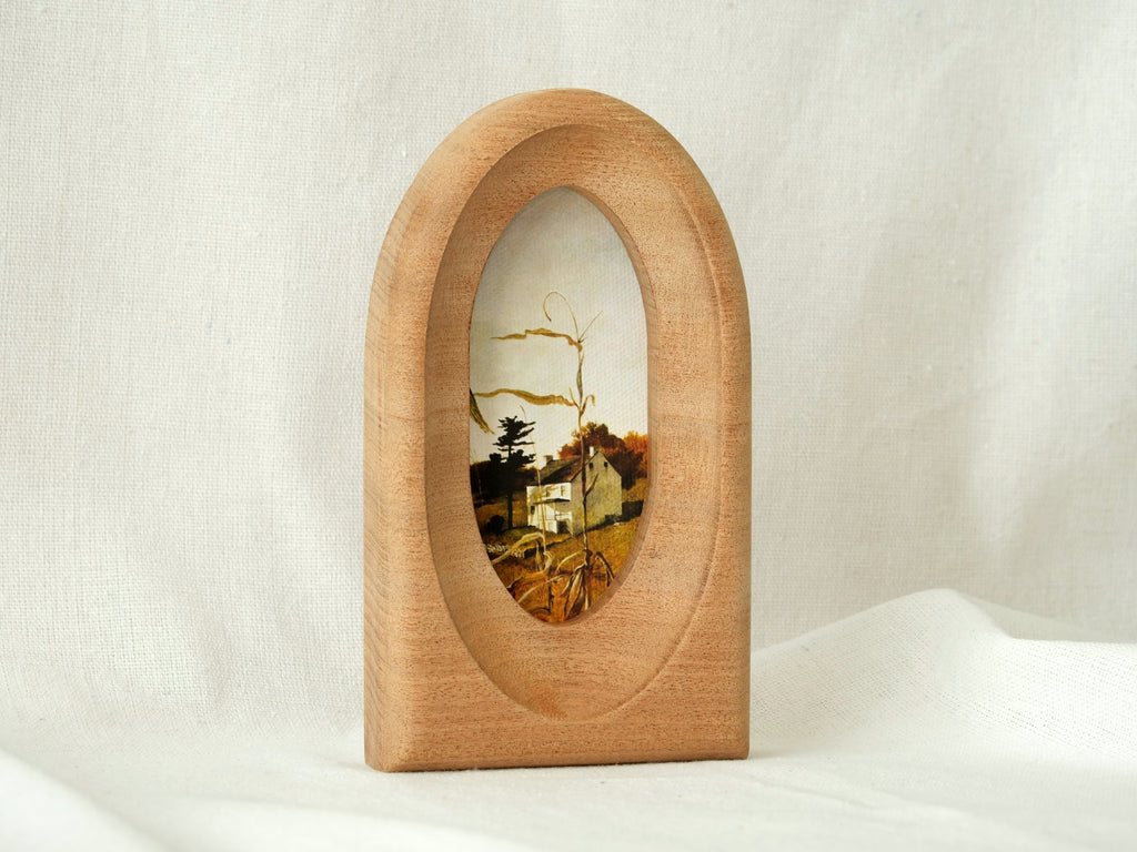 Standing view of the arched wood art frame, showing its elegant portal silhouette and stable architectural design.