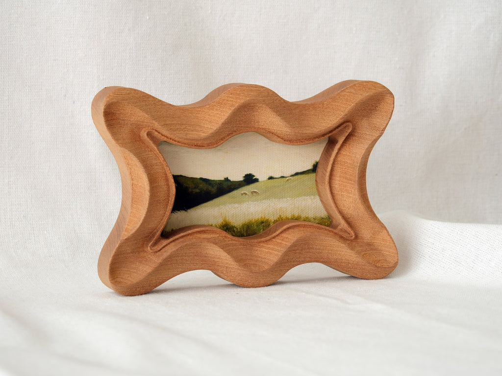Standing view of the rippled wave wood frame, showcasing its dynamic undulating edges and stable artistic presence.