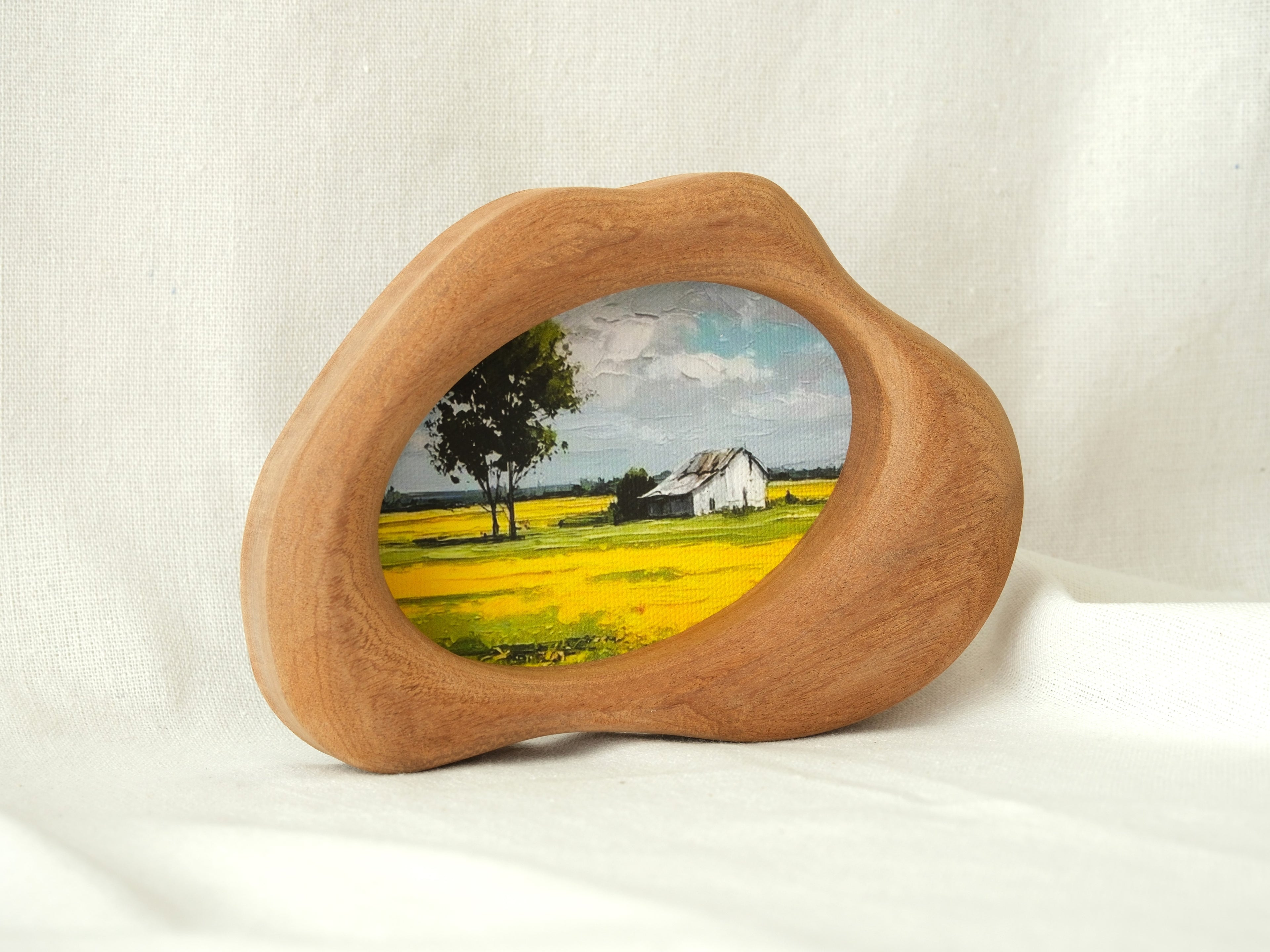 Standing view of the cloud-shaped wood art frame, demonstrating its stability and elegant organic silhouette.