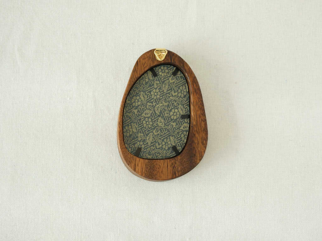 Rear view of the Waterdrop solid wood frame, showcasing its organic pebble-like profile and the integrated gold hanger for easy wall mounting.