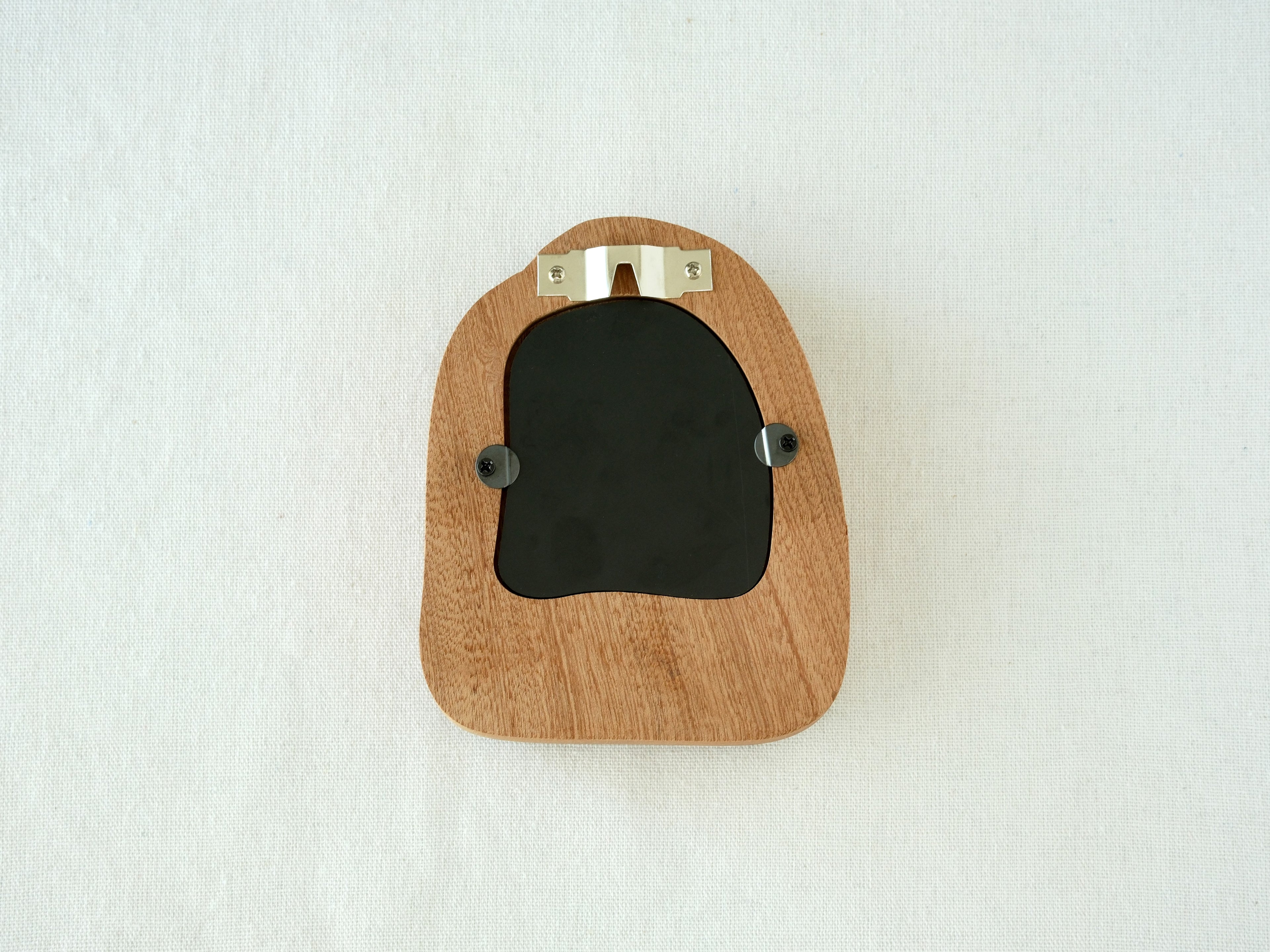 Back view of the house-shaped frame, featuring a sturdy sawtooth wall hanger and secure swivel tabs for artwork.
