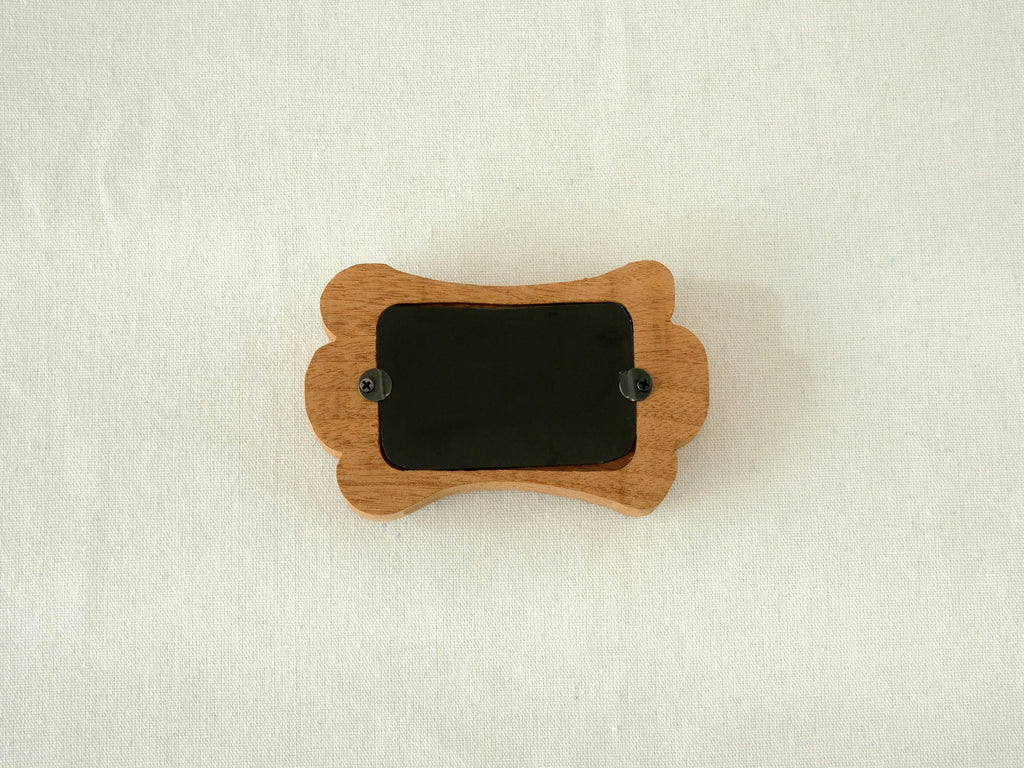 Back view of the bone-shaped frame, showing the clean wood finish and two swivel tabs for easy desktop photo display.