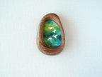 Front view of the Waterdrop handmade solid wood art frame featuring birds flying over a lush forest, highlighting the organic pebble shape and natural wood grain.