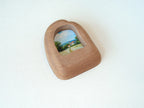 Alternative side angle of the house-shaped frame, showcasing the unique undulating texture and rich natural wood grain.