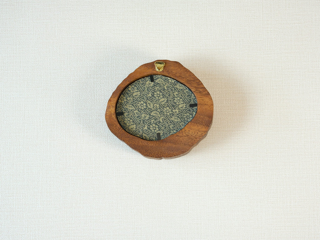 Rear view of the lake-shaped organic solid wood frame, revealing the uniquely patterned blue and gold textile backing and the integrated gold wall hanger.