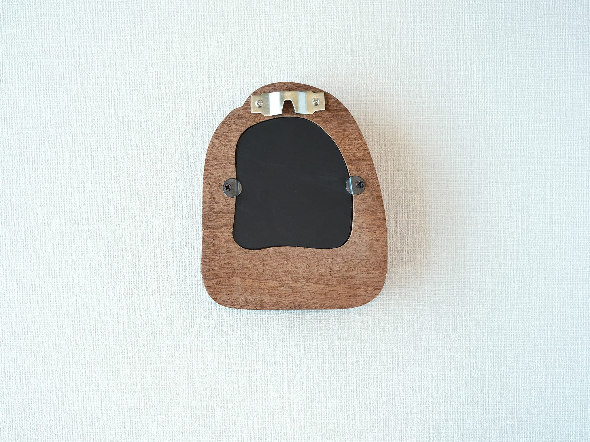 Back view of the house-shaped frame, featuring a sturdy sawtooth wall hanger and secure swivel tabs for artwork.