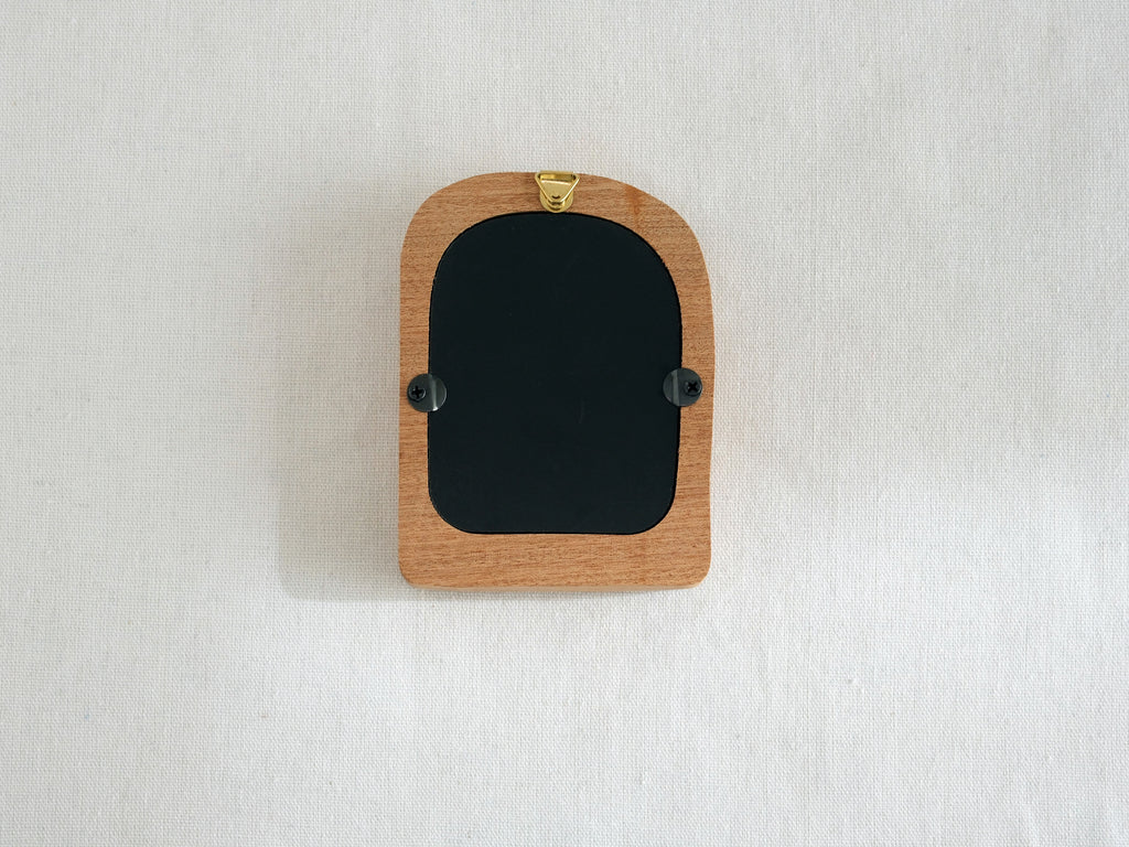 Back view of the soft arched wood frame, showing the integrated wall hook and secure swivel tabs for easy photo setup.