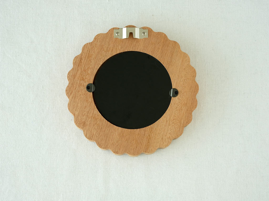 Back view of the sunflower circular frame, showing the wall-mounting hook and easy-open tabs for swapping photos.
