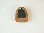 Back view of the house-shaped frame, featuring a sturdy sawtooth wall hanger and secure swivel tabs for artwork.