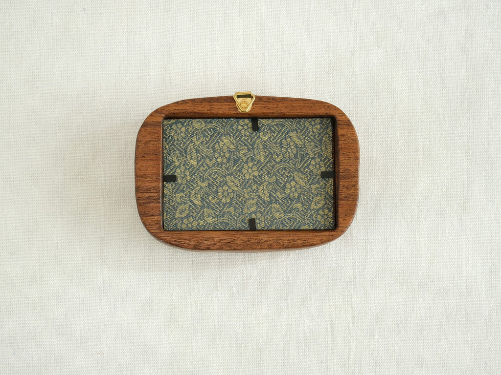 Back view of the walnut frame showing the wall hanger and easy-to-use clips for swapping art or personal photos.