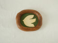 Front view of a Fomjia handcrafted organic-shaped wood frame featuring a minimalist cream dove illustration on a forest green canvas background.