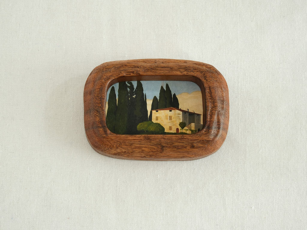 Handcrafted South American walnut wood picture frame with organic chunky shape and a landscape art print.